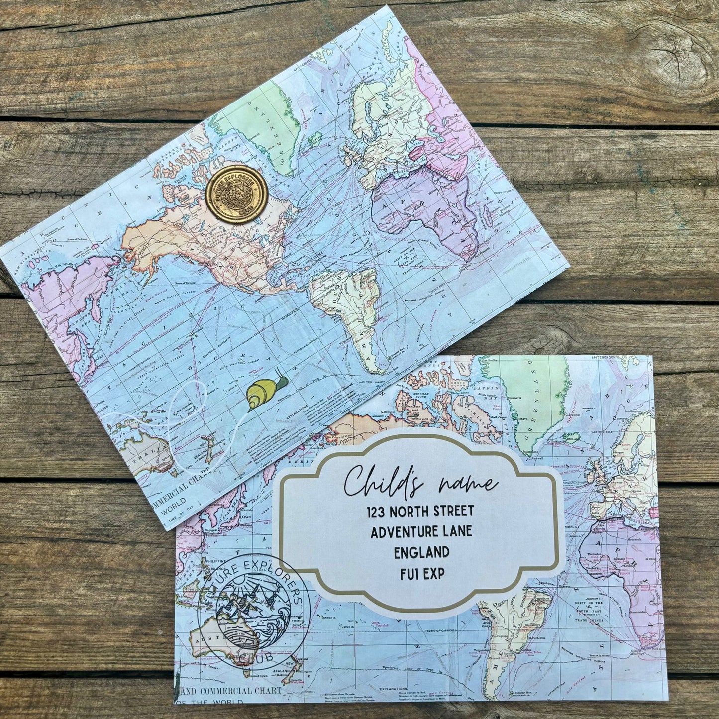 Two envelopes printed with map design and gold seal