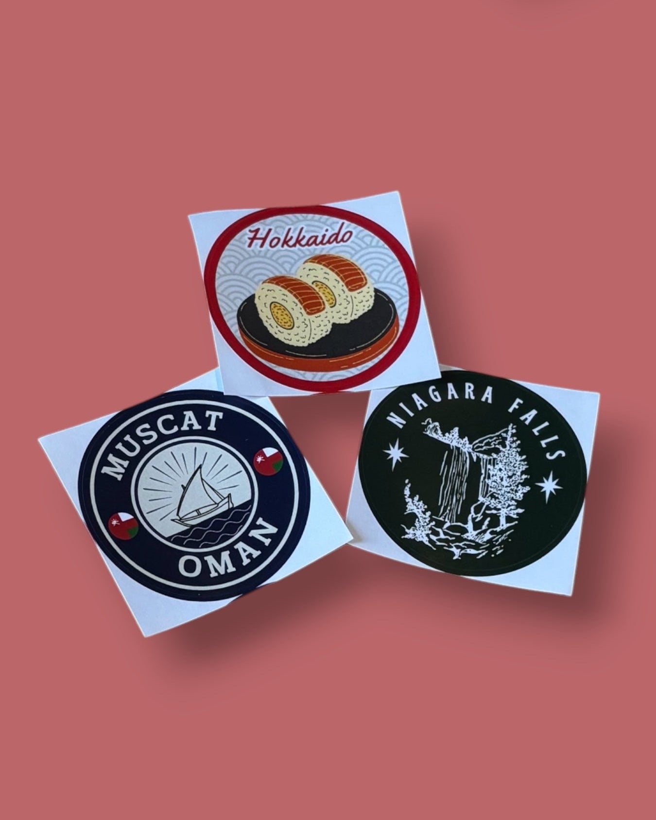 Collection of travel-themed stickers on a pink background